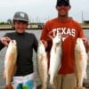 Splendora anglers Ed and son Noah Dain with their string of reds and specks-