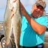 High Island native Dennis Boeker with a couple of surf caught specks caught on a #28 mirror lure