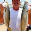 Mike Therrel of Livingston hefts 2 of his am trout caught on a mirror lure