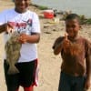 The Brown brothers hold up their dads drum he caught on shrimp.