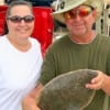 Kim Hollock of Spring and Ted Baty with a nice flounder caught on a Lil Fishy.