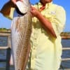 Joseph Tran of Katy, TX hefts a nice red caught on finger mullet.