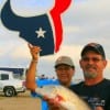 GO TEXANS Sonya Hinojosa says as her husband Joe holds up this nice redfish caught at Rollover Pass.