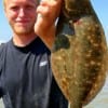 Andrew Cain of Dayton, TX hefts this flounder caught on finger mullet.