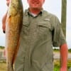 ,Drue Lyon of Spring TX hefts his 24 inch red he caught on finger mullet.