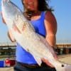 Yelling for help when hooking up to this really nice red Kim Arnold of Lufkin, TX caught it while fishing a finger mullet.