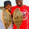 The Taylors of Houston heft their flounder catch they caught on miss nancys mud minnows.