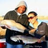 Christina and Andre Wright of Houston caught and released a 40 incher but kept these two slot reds fishing shrimp.