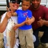 The Wincher Family of  Houston, shows off moms 24 inch slot red she caught on shrimp.