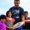 The Dolagarza familia of Edinburgh, TX show off their nice drum caught on shrimp.