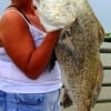 MY BIGGEST EVER screams Vicky Covey of La Porte, TX as she hefts a 37 inch-25lb drum she caught on cut croaker before releasing it.