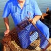 Talco, TX angler Paul Miller checks his crabtrap with a few nice Blue-Claw invited for supper.