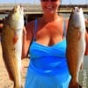 Baytown anglerette Kristina Milburn fished live finger mullet to catch these two nice slot reds