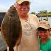 Father and son, Mark and Mark JR heft this nice flounder caught on a finger mullet