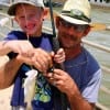 Grandpa and grandson, Steve Thompson with 6 yr old Jonathon of Dayton TX with Jon's first catch, a yellow tail caught on shrimp